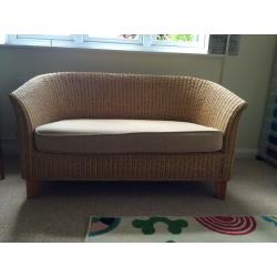 2 seater compact wicker sofa with beige cushion