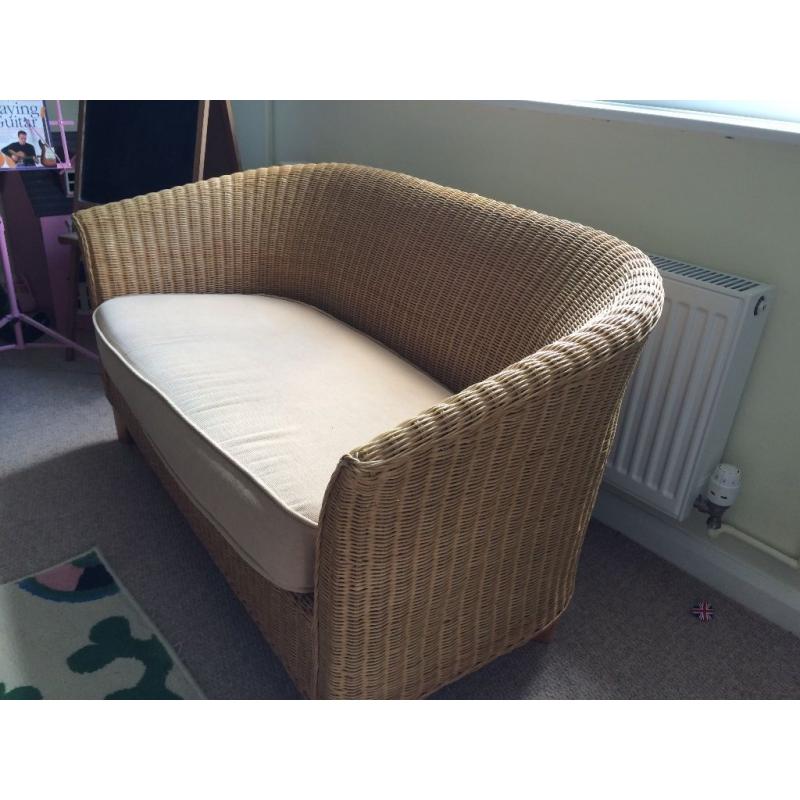 2 seater compact wicker sofa with beige cushion