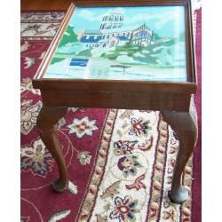 Unique coffee table with beautiful embroidery under glass.